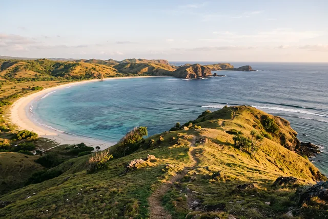 View from Bukit Merese over Tanjung Aan bay in south Lombok, with a pale beach and green coastal hills