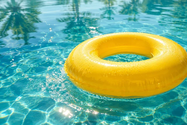 A yellow inflatable ring in clear pool water